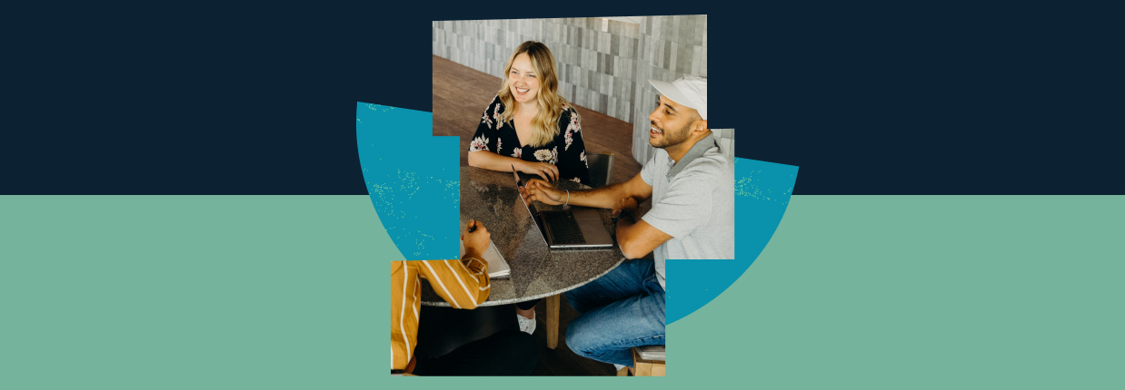 Two marketers collaborating over a laptop with abstract design elements in the background