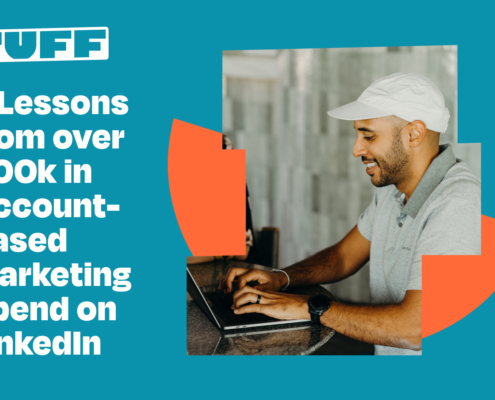Man smiling while working on laptop with blog title '5 Lessons from over 400k in Account-Based Marketing Spend on LinkedIn' overlay.