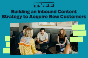 A collaborative team meeting with a laptop, illustrating the development of an inbound content strategy