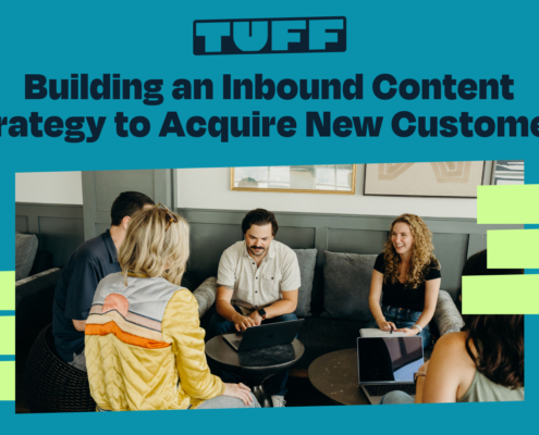 A collaborative team meeting with a laptop, illustrating the development of an inbound content strategy