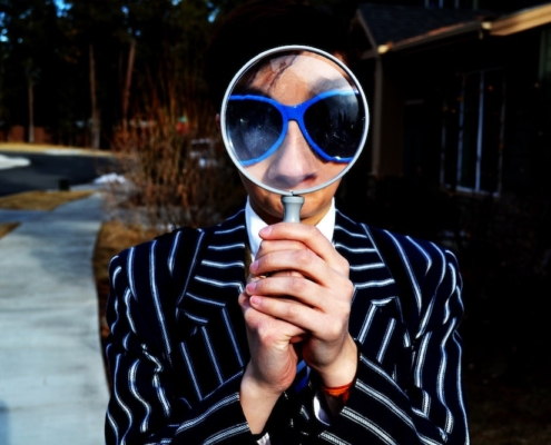 man looking at magnifier