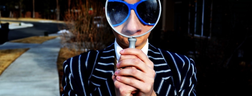 man looking at magnifier