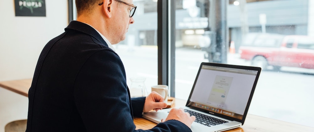 Man typing on his computer.