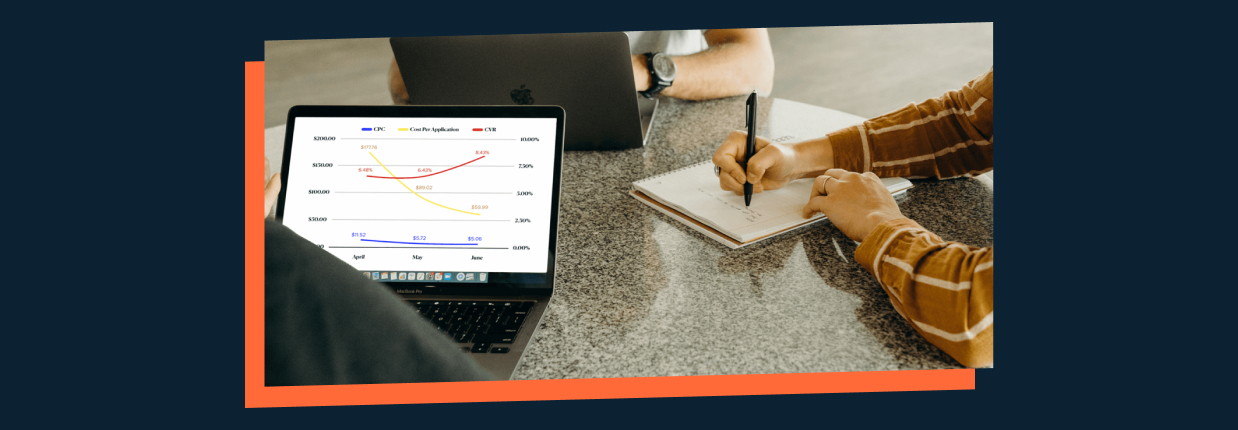 Two professionals discussing over performance analytics on a laptop screen