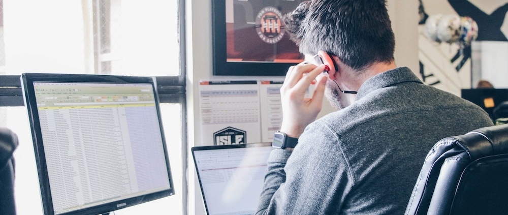 A man using social listening tools on his computer.