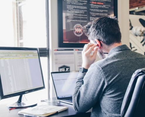 A man using social listening tools on his computer.