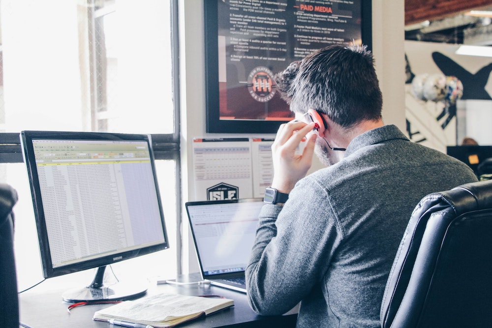 A man using social listening tools on his computer.