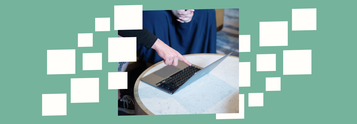 Person pointing at laptop screen with potential website visitor psychology analysis