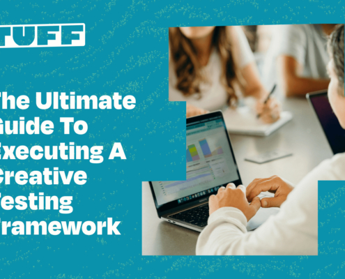 Professionals analyzing data on computer screens with 'The Ultimate Guide To Executing A Creative Testing Framework' title overlay